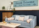 Sofa upholster in Sandy lane with vertelli trim, striped cushions, some with helter skelter trim. coffee table in foreground and navy wooden panels behind. Design by Gemma Wright, Photography by Robin Quarrelle